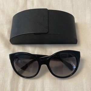 Prada sunglasses. Round cat eye shape - quite luxury aesthetic.